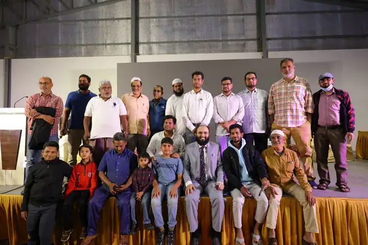 A large community group on stage at the close of the expo